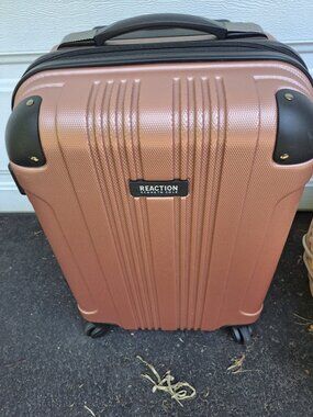 Kenneth Cole Reaction Out of Bounds 20-inch carry-on features a rose gold hardsh